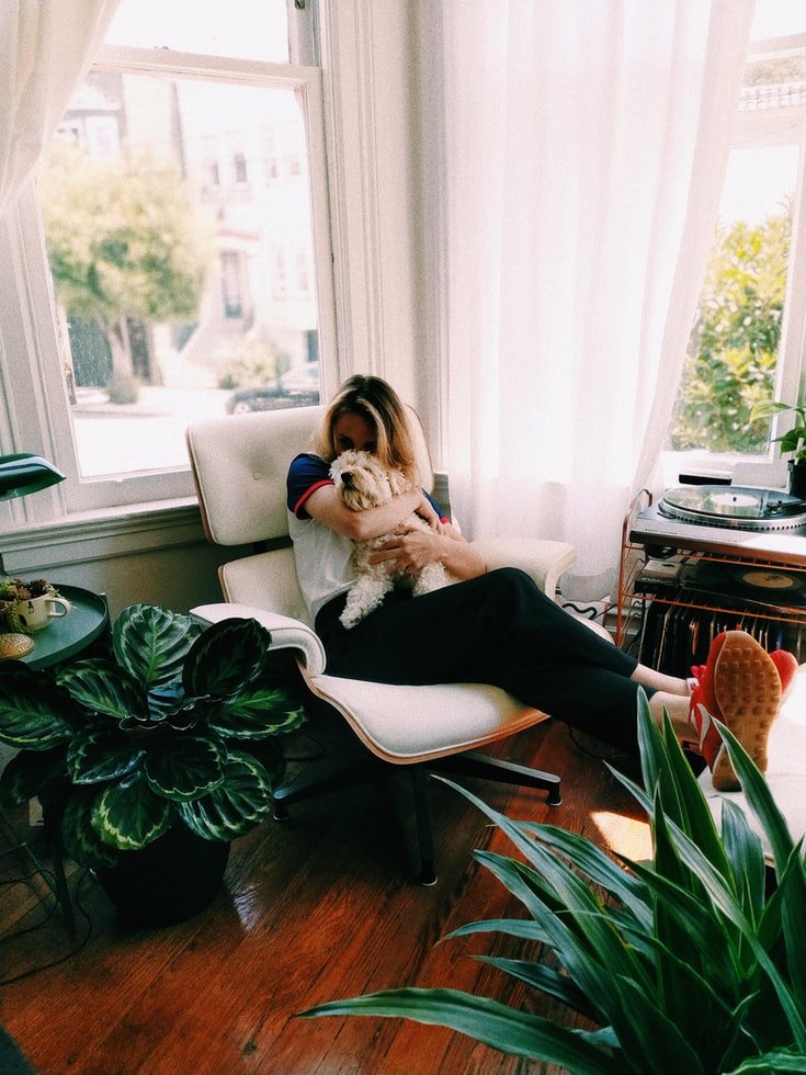 Happy puppy owner enjoying snuggling with their new dog.